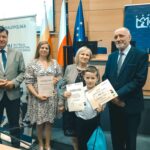 R. Kosowski, H. Cimer, prof. J.T. Duda i laureat konkursu wraz z opiekunem