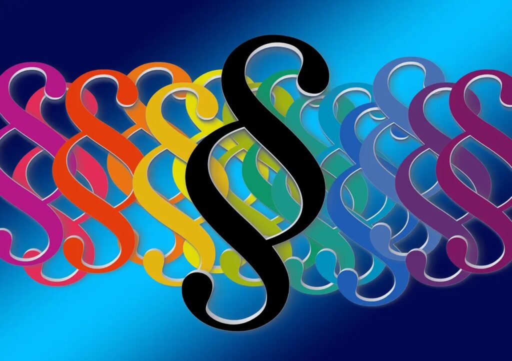 Obrazek przedstawia paragrafy jako symbole regulacji prawnych