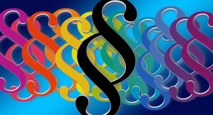 Obrazek przedstawia paragrafy jako symbole regulacji prawnych